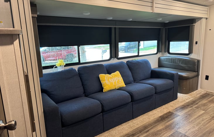 The standard RV couch and dinette was replaced with this extra long Ikea couch with storage bins underneath! We kept one bench for extra seating.