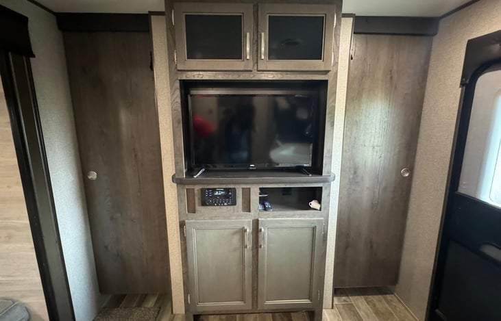 This is the entertainment center you have a Tv and a Bluetooth/FM stereo and some storage space for your items.