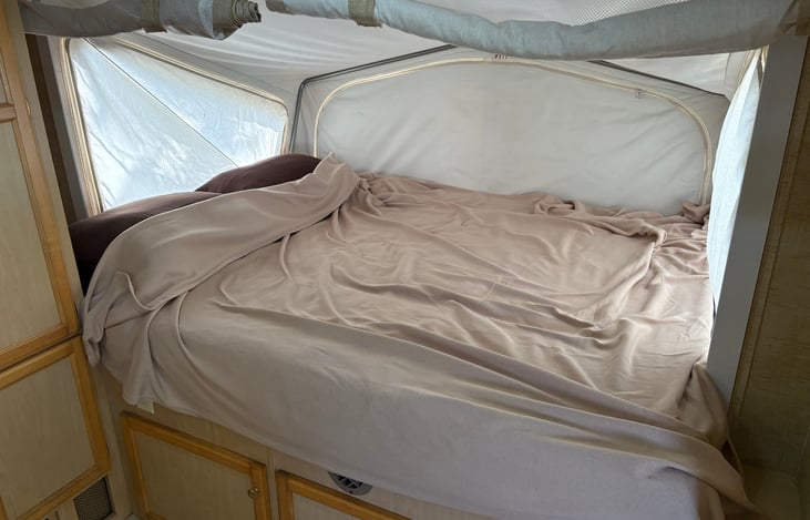 Queen bed complete with blankets, pillows, and sheets