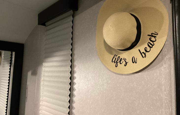 Master bedroom has large window with shade drawn.