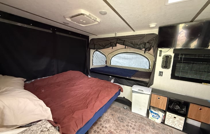 full sleeping area with pop out double size bed open; queen bed down and back ramp closed up.  Plenty of room for a small family or group of friends