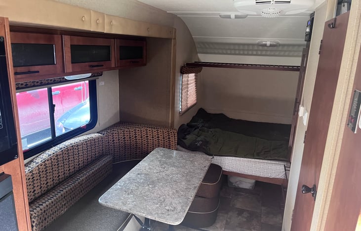 This camper trailer sleeps 4 adults. The table and seating area convert to another bed. Also has a radio and small television with dvd player.