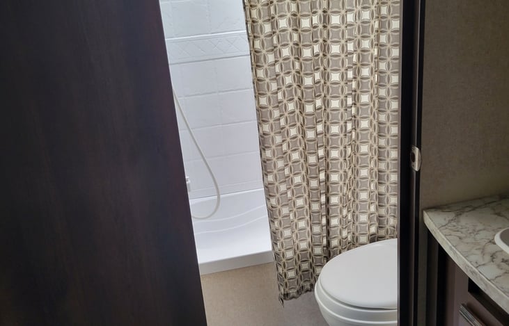 Bathroom toilet and shower with small bathtub