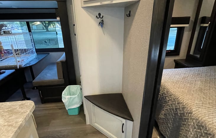 Coat hanging area with cabinets for storage