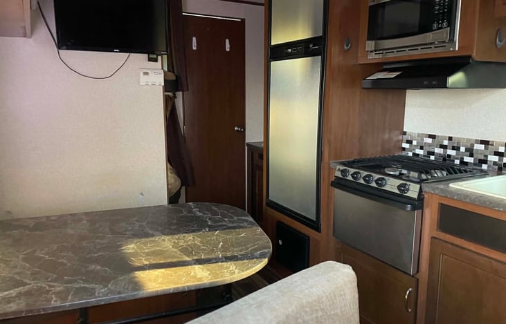 Main area with dining table (turns into double bed), kitchen, Fridge and Freezer, TV