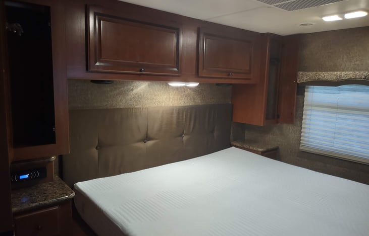 closets above nightstands can store hanging clothing