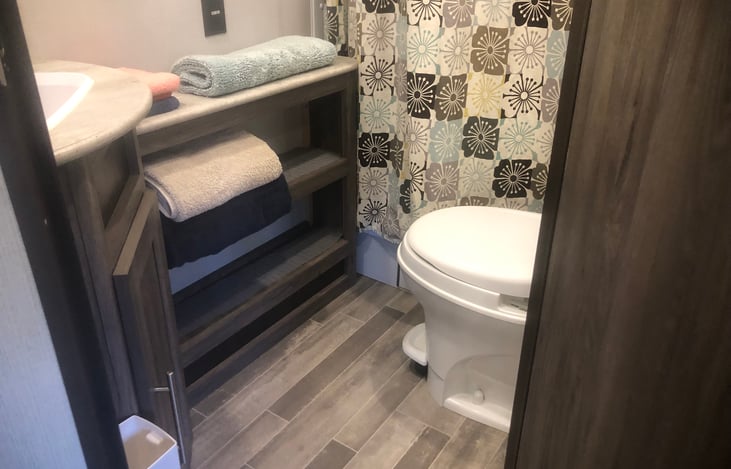 Bathroom with great storage. Extra tall shower with exhaust fan.  Flush toilet.  Towels, wash cloths and bathmat come with rental.