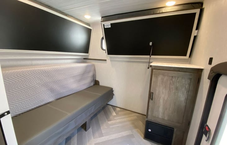 Spare room with two bunk beds folded up. And queen bed put up to become another couch if needed.