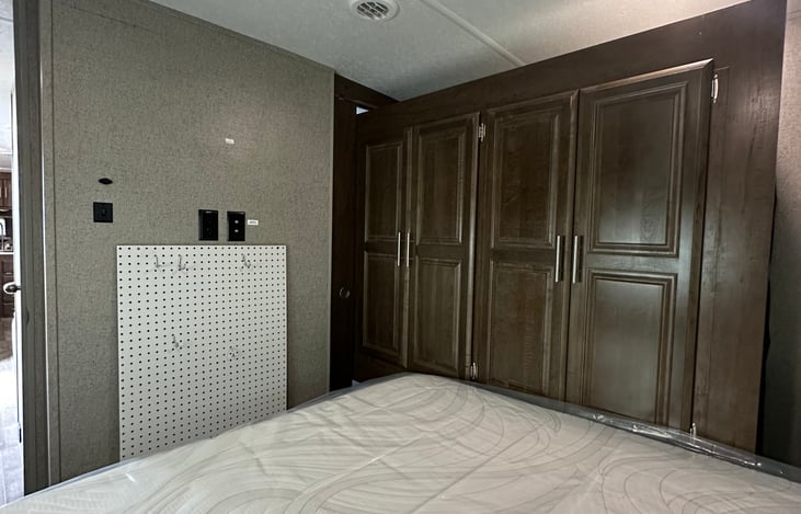 Bedroom- clothes storage/closet space that leads to bathroom area