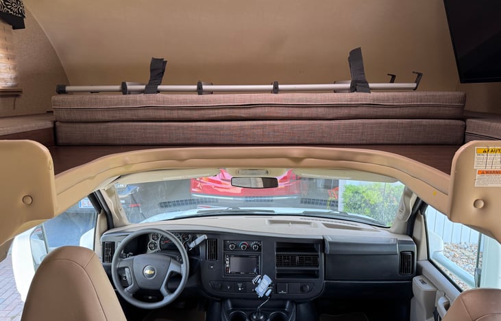 Cab with overhead bed collapsed for driving