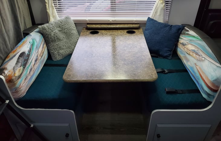 Dinette converts into a bed. 3 seat belts can be stowed under seats if not in use.