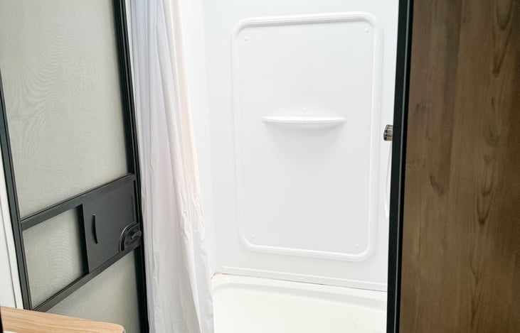 Standard RV size toilet and shower in the bathroom