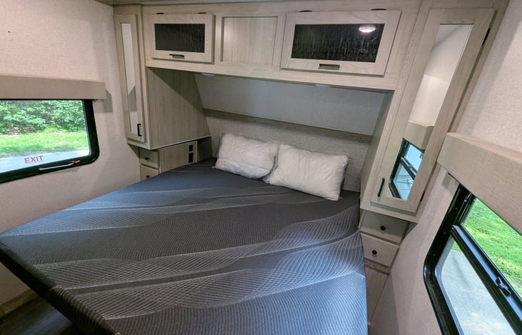 Nice bedroom with comfy King size bed, ample storage cubbies and windows for natural sunlight.