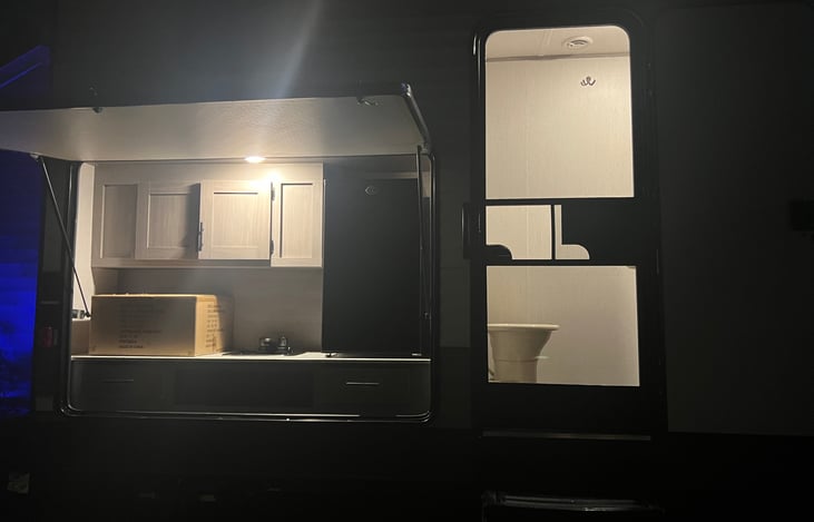 Light kitchen near bathroom.