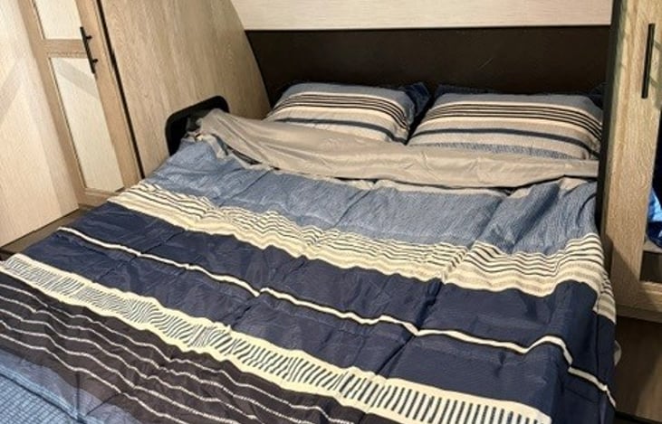 Front Queen bed. Nightstand and closet on each side.