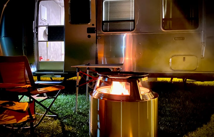 Smokeless Solo Stove fire pit with a removable cast iron grill included in rental.