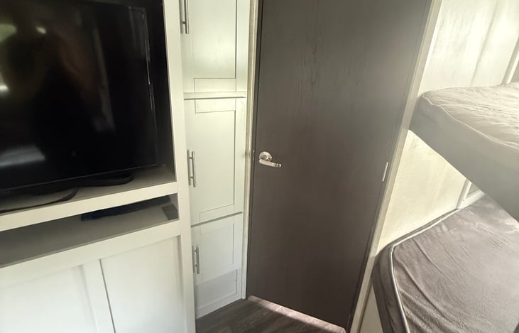 Storage near bathroom door.