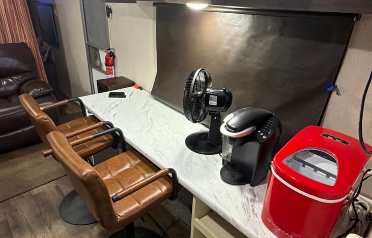 Dining counter with leather adjustable bar stools.