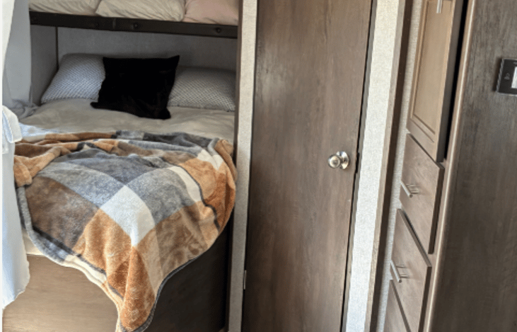 The comfy full-size bed has a privacy curtain. We removed the top bunk to make the area more accessible for two adults. There are two USB ports at the foot of the bed.