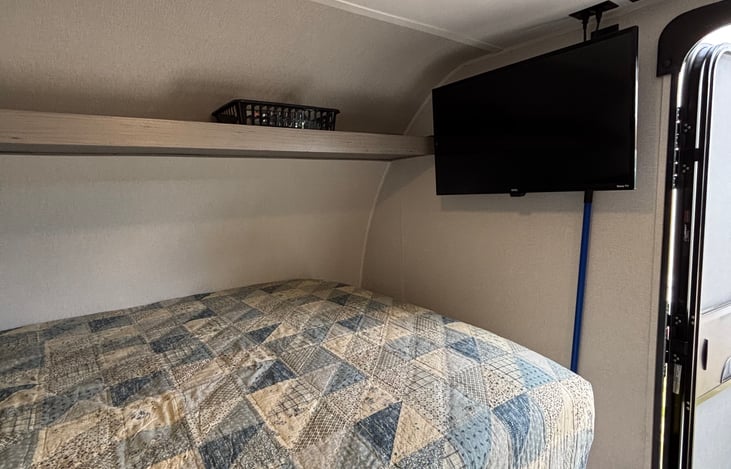 Tv, storage shelf, and DVD player.