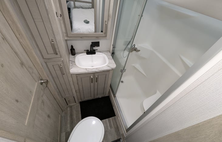 Experience a spa-like retreat with a walk-in shower, porcelain toilet, and spacious vanity. Large medicine cabinets provide ample storage, making this private master ensuite a true luxury upgrade.