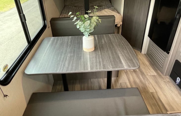 Dinette with storage under each seat. Quickly and easily converts to a bed!