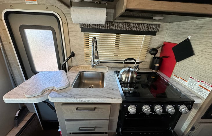 Make some tasty meals, flip top counter extension, stainless steel sink. Three burner gas stove.