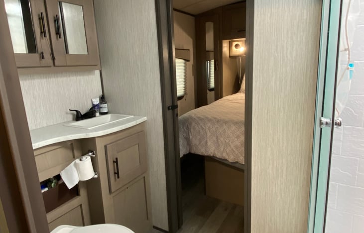 The rest of the full bath and a little peak of the main bedroom.