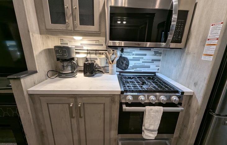 Chef’s dream galley! Features a massive 18 cu. ft. fridge, residential microwave, and 3-burner stove. Enjoy the solid-surface islands, deep sink, and pantry—perfect for feeding the whole crew.