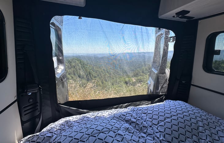 The back doors have a bug / privacy screen that don't block the view from the back - either as a sofa or king bed!