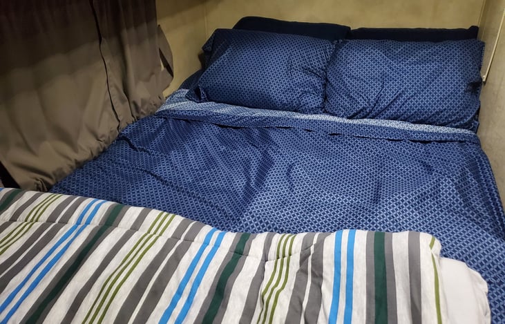 Master bed. Linens, pillows, and blankets are provided with all rentals.