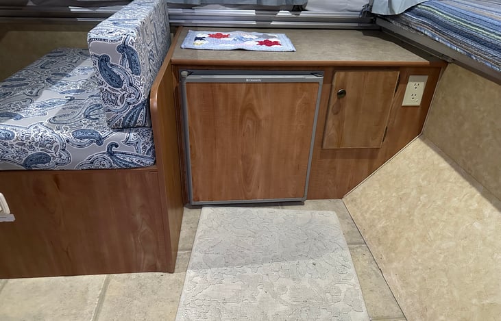 Fridge.  We have a small microwave that sits on the top of the cabinet, if you want to take/use it.