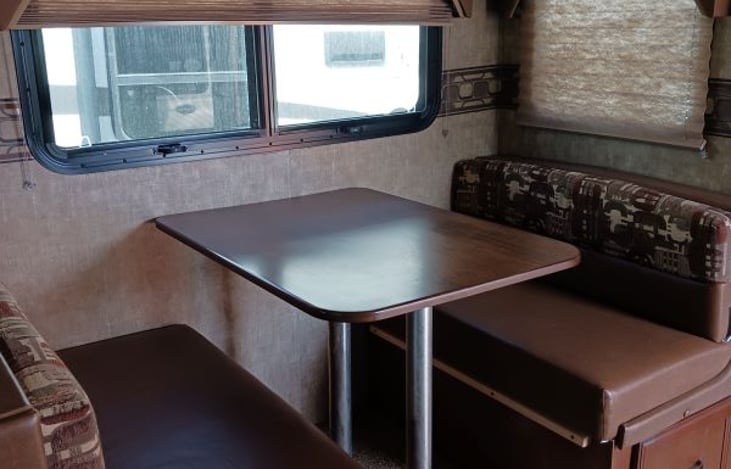 Cute dinette with storage underneath. Can push down table for another sleeping area, if needed. Cushions pull down for sleeping comfort.