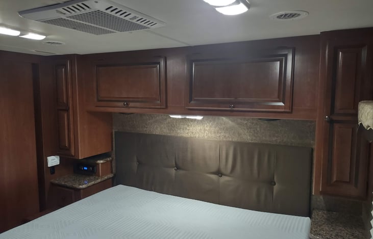 plenty of storage above bed and nightstands