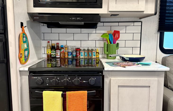 A kitchen complete with stove, oven, microwave, and prep room! Fully stocked kitchen with pots and pans included.