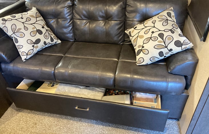 Storage under couch that folds down into another bed