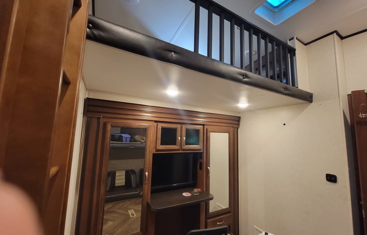Bunk room. Loft above entertainment center and storage.