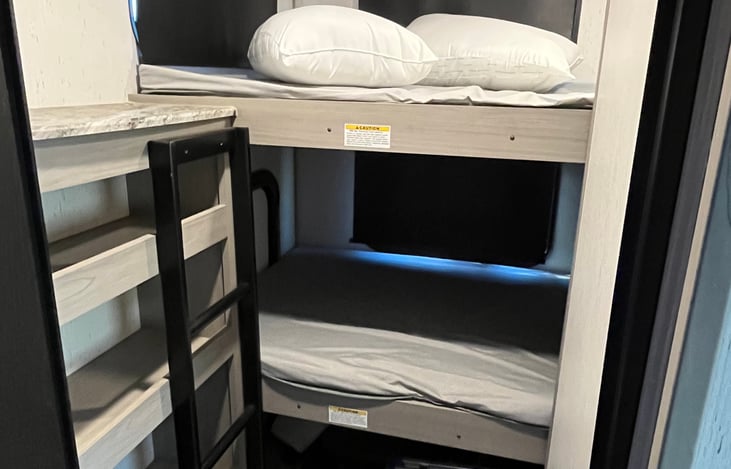 There are 3 possible bunk beds here. We keep the bottom mattress out for extra storage but can add it for renters if needed/wanted