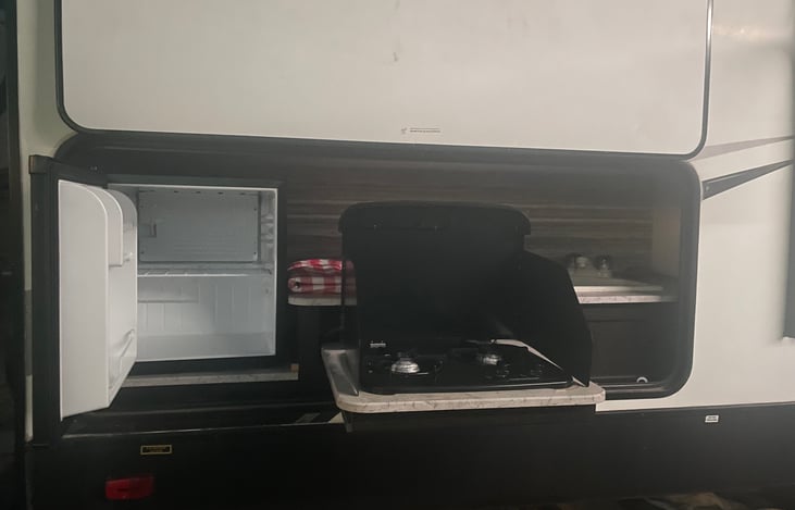 Outdoor kitchen. Fridge,propane stove, and sink.