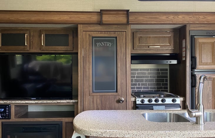 Large kitchen island and a dedicated pantry big enough to hold all of your essentials.