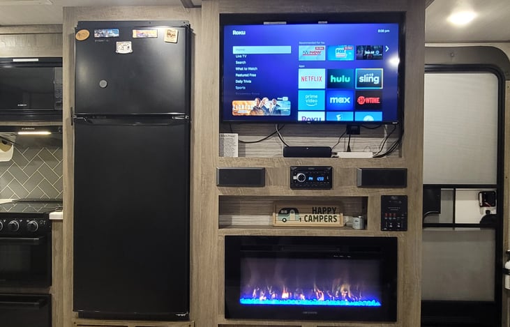 Roku TV and sound bar. Electric fireplace.