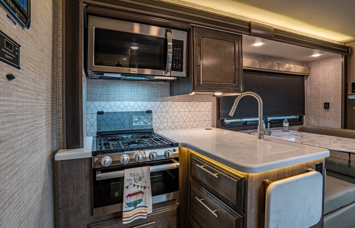 The adjoining kitchen and dinette areas make for efficient food prep and eating.  A flip up extension can be used to increase counter space.