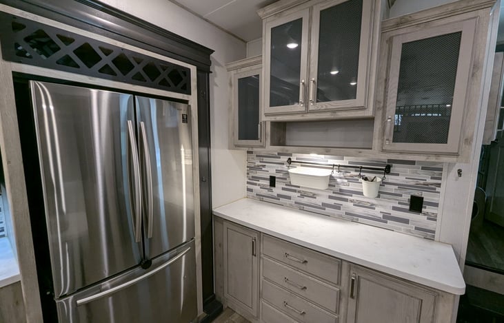 Chef’s dream galley! Features a massive 18 cu. ft. fridge, residential microwave, and 3-burner stove. Enjoy the solid-surface islands, deep sink, and pantry—perfect for feeding the whole crew.