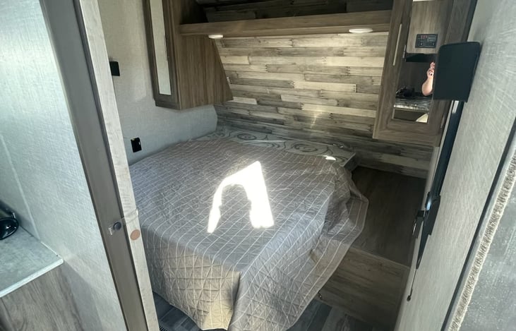 Private bedroom with Queen bed and storage on both sides and above.