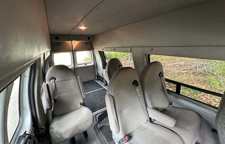 Super comfy reclining passenger seats w/ integrated seat belts, adjustable phone holders for watching videos, and USB-A/C charge ports.