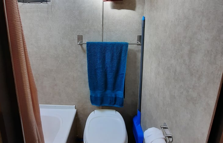 Bathroom with tub/shower, storage on door (not shown in pic)