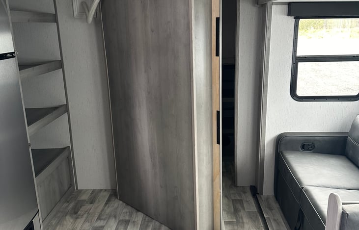 The entertainment (t.v. and fireplace) wall opens to access a convenient out of the way pantry.