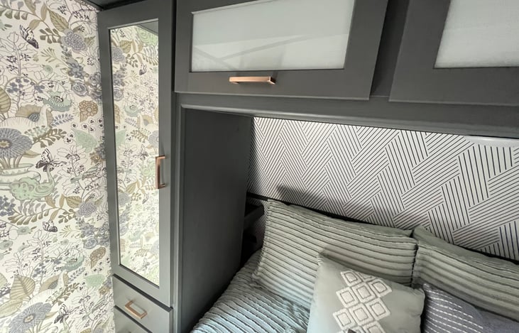 Ample storage surrounding bed. Including hidden storage behind wardrobe and under bed.