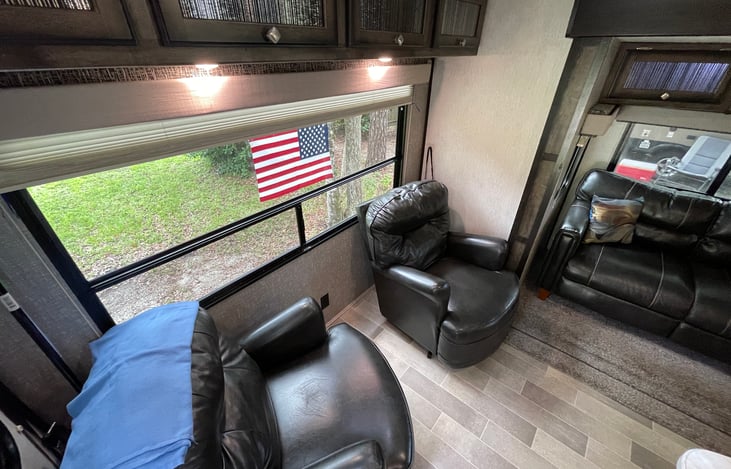 2 Swivel Chairs with reading lights by large window