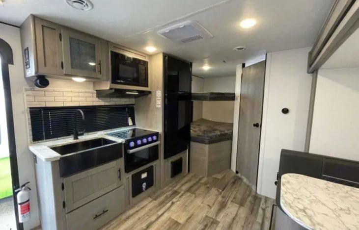 Interior view of kitchen and full size bunks